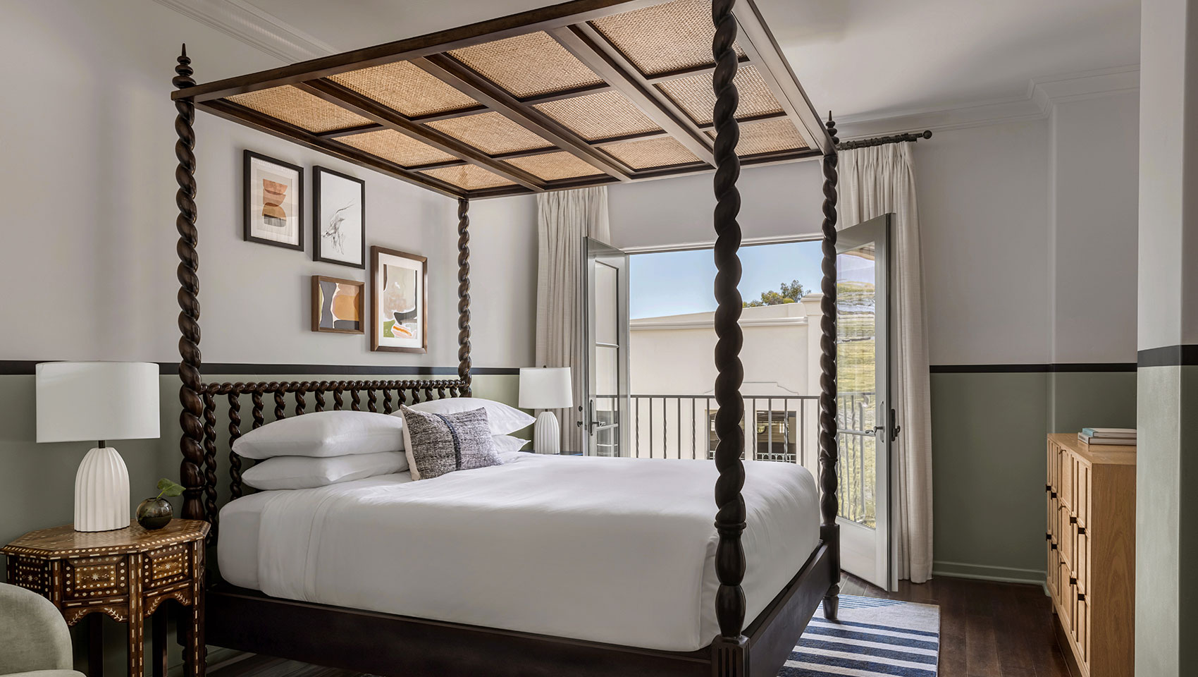 king bedded guest room with four poster canopy bed