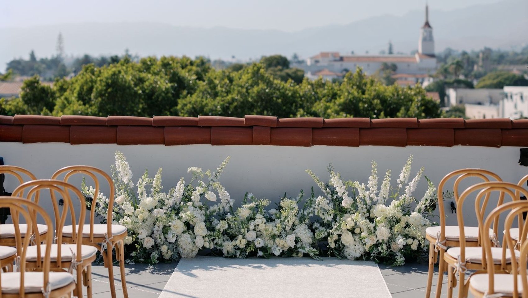 Rooftop wedding ceremony aisle with city views