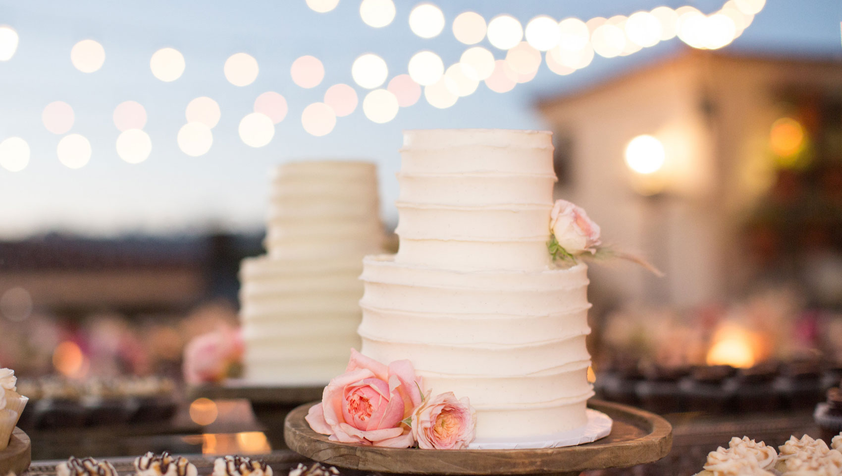 white wedding cake with pink flowers