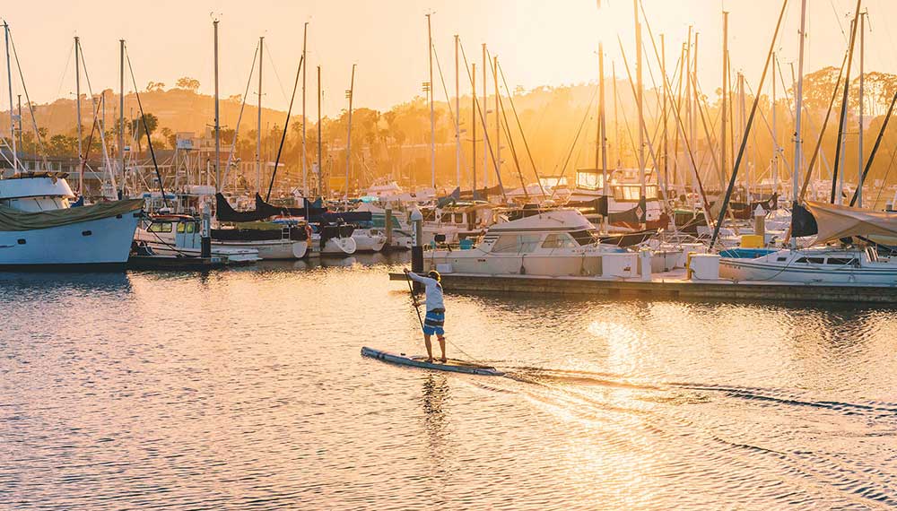 man stand up paddle boarding