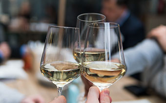 Cheersing with white wine