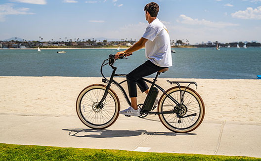 biker on a boardwalk with ocean views